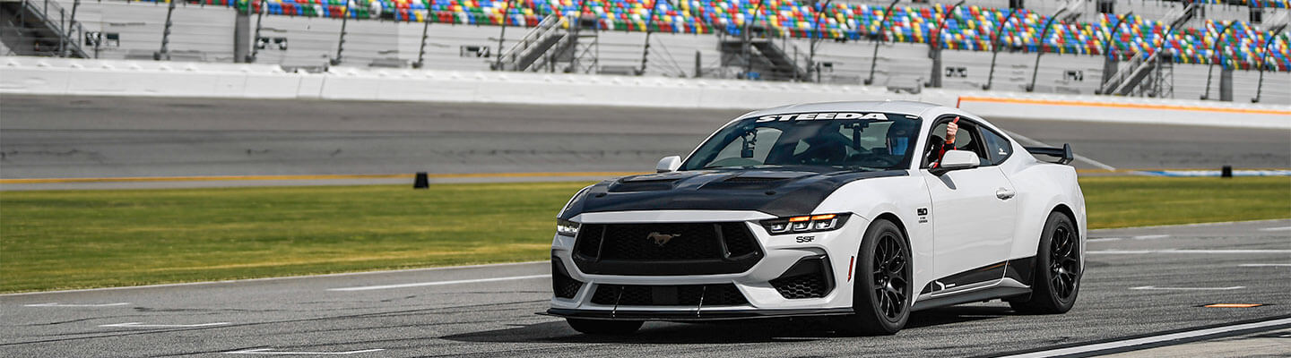 White 2024 Ford Mustang GT HPDE build at speed on track at Sebring International Raceway