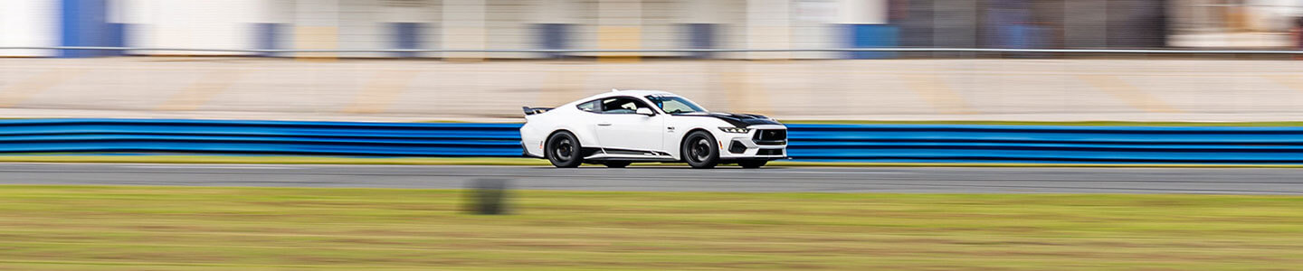 White 2024 Ford Mustang GT HPDE build at speed on track at Sebring International Raceway - Stage 2
